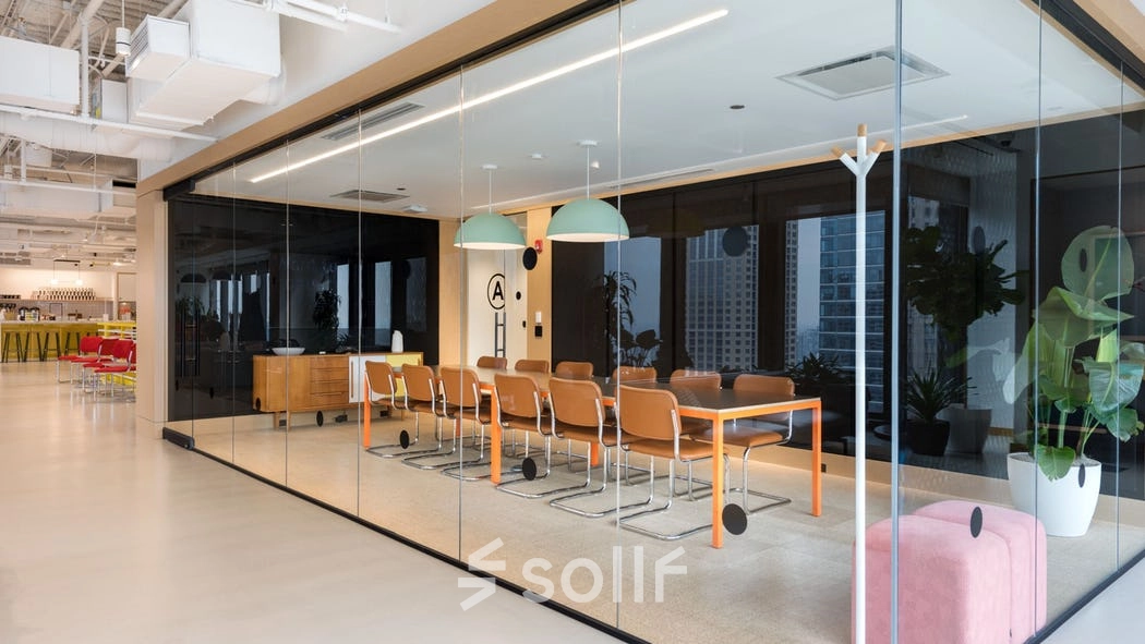 Modern office space for rent at Grzybowska 60, Warsaw Wola, featuring a sleek conference room with glass walls, stylish lighting, and contemporary furniture.