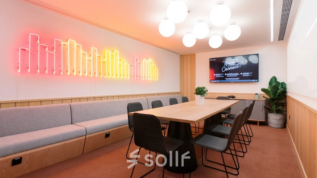 Modern office space at Grzybowska 60, Warsaw Wola with stylish lighting, long table, and chairs ideal for office space rental.