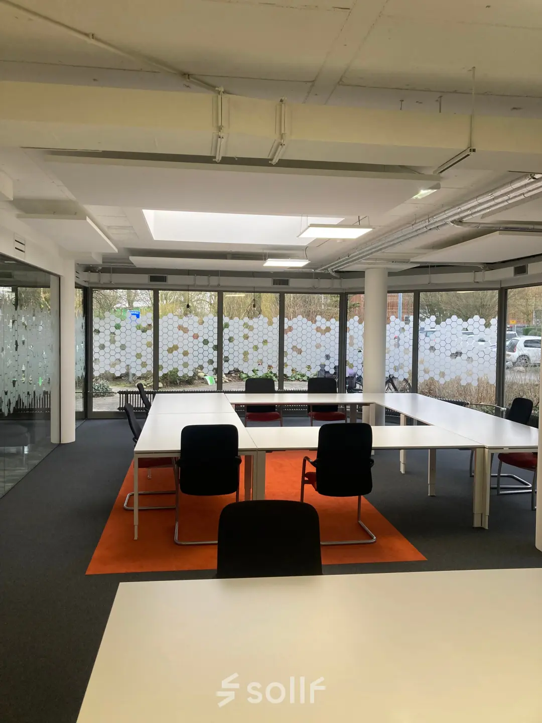 Bright office space with large windows and modern furnishings available for rent at Houttuinlaan 4, Woerden.