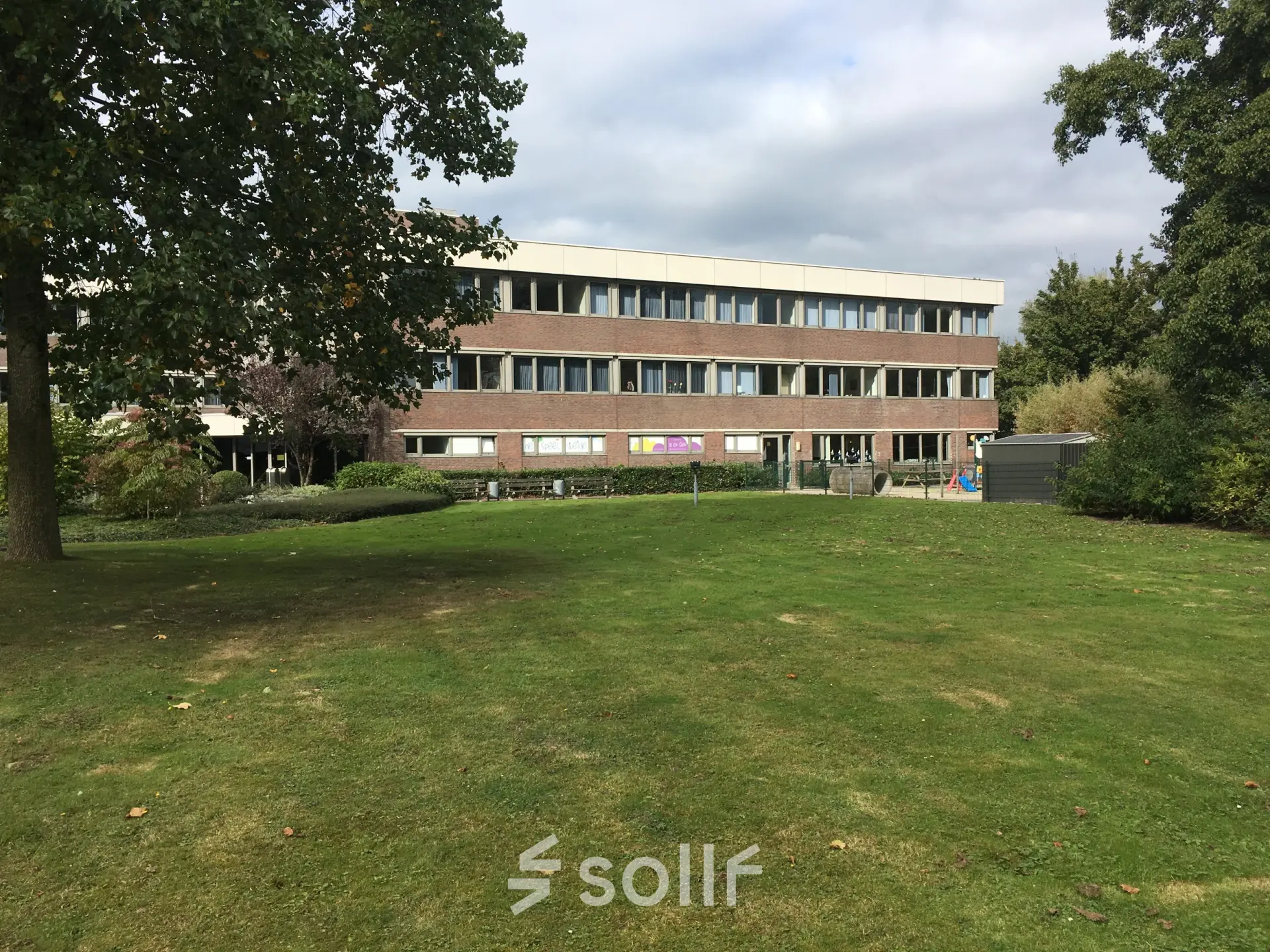 Exterior view of the office building located at Houttuinlaan 4, Woerden, ideal for rent office space with spacious lawn.