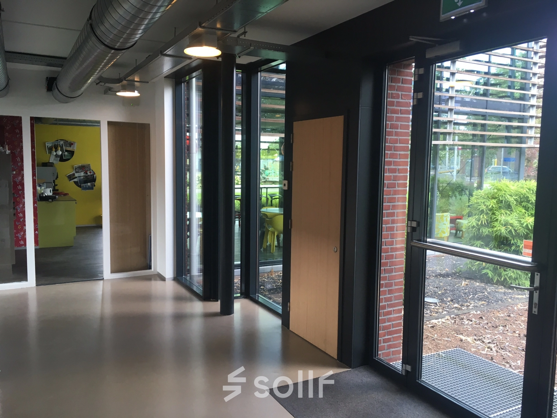Bright entrance area with large windows and modern design elements located at M.A. Reinaldaweg 2d, Woerden, ideal for those looking to rent office space.