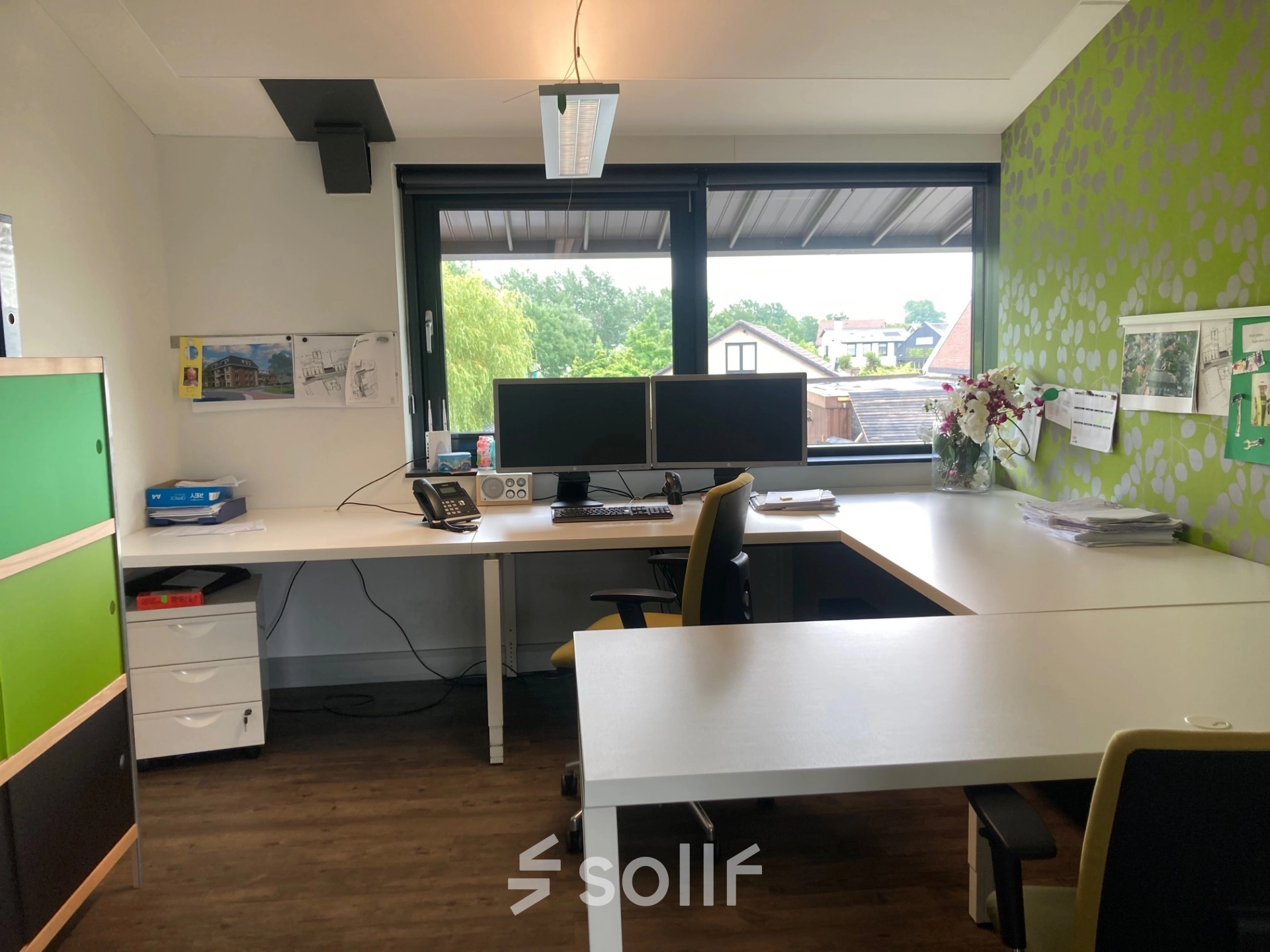 Modern office space with large desks, dual monitors, and bright decor at M.A. Reinaldaweg 2d, ideal for those seeking office to rent in Woerden.
