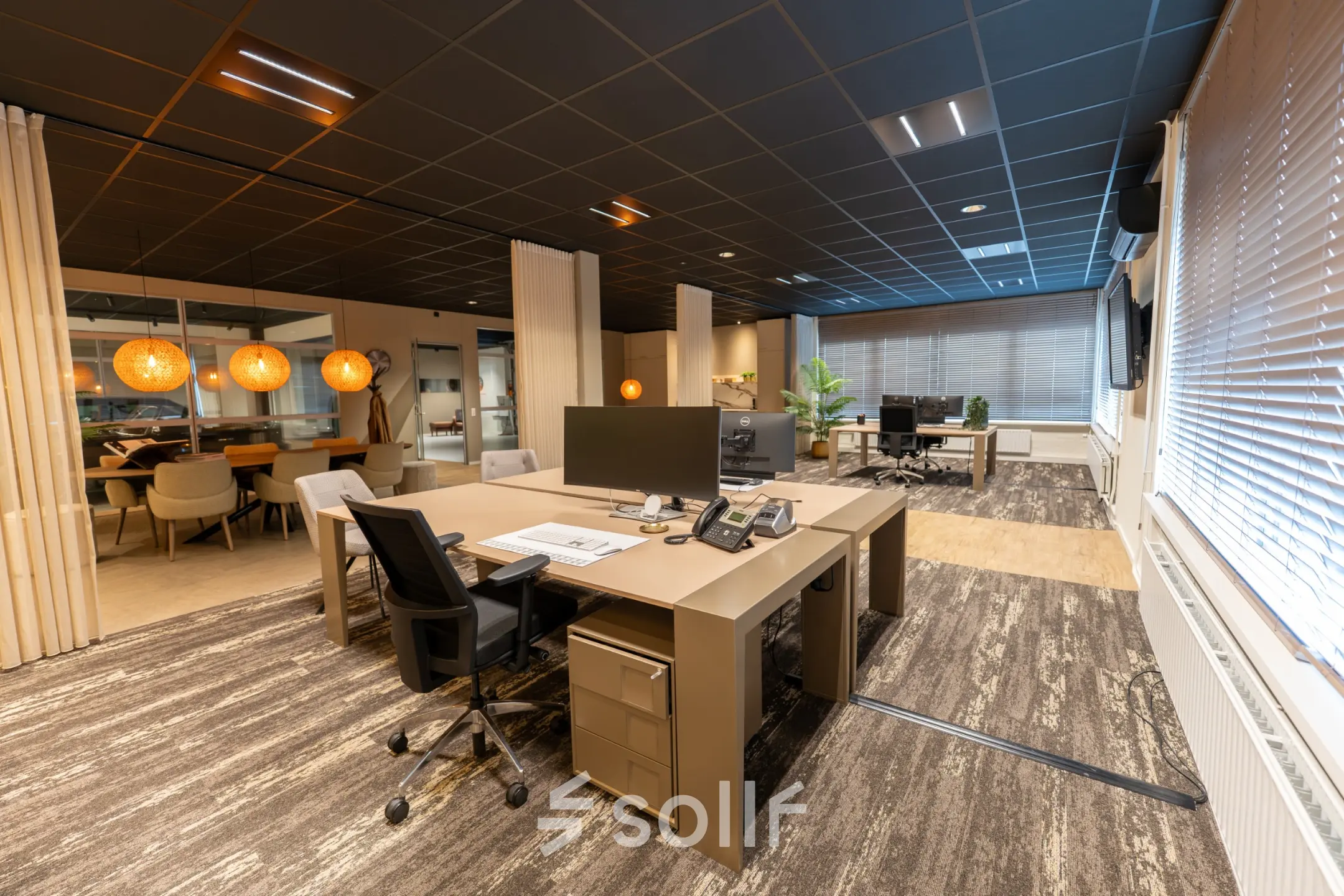 Modern office space with large desks and chairs, computer monitors, and warm lighting at Vijzelmolenlaan 9, Woerden, ideal for rent office space.