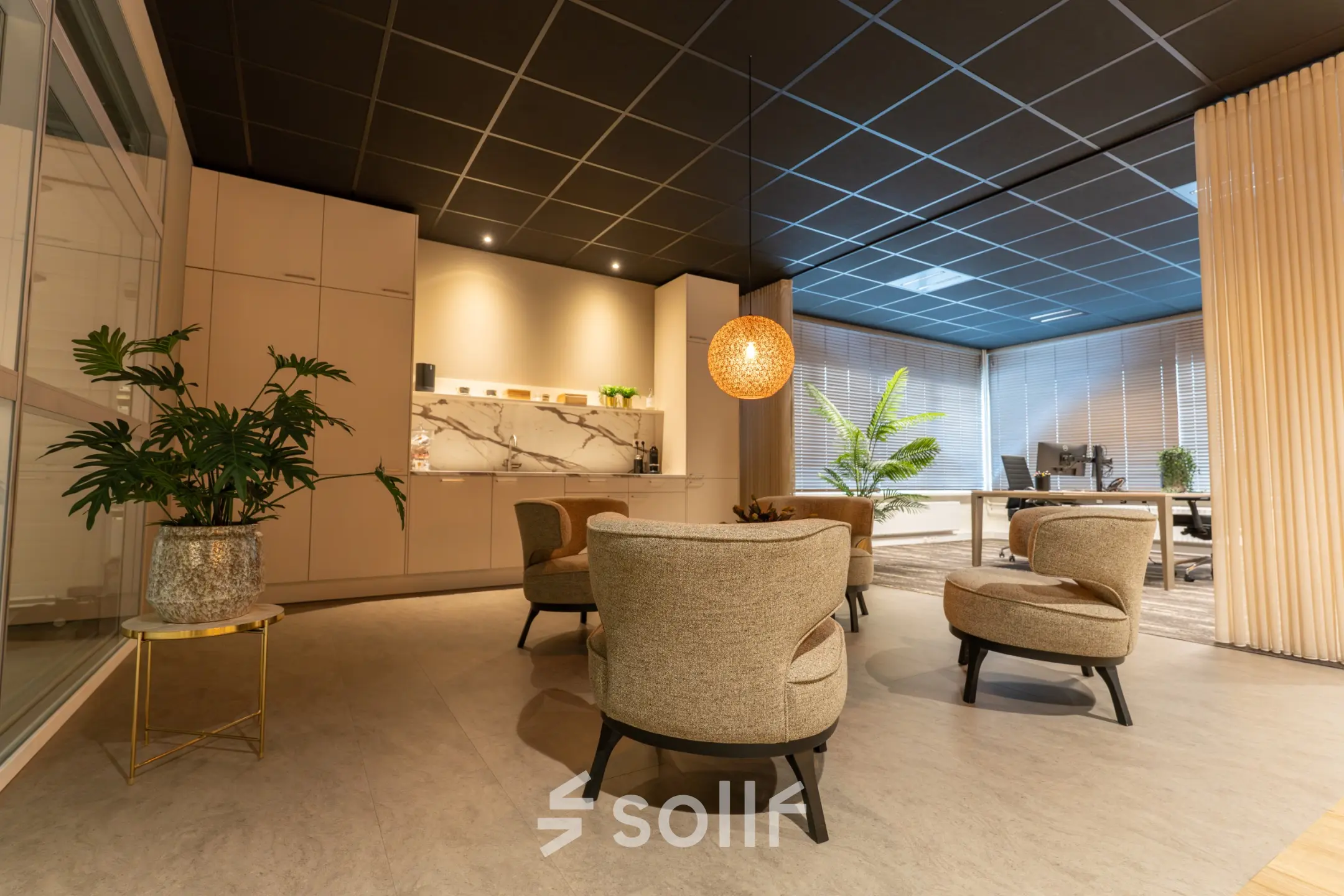 Furnished office lounge with modern seating and plants at Vijzelmolenlaan 9, Woerden, highlighting an inviting spot for office space rental.