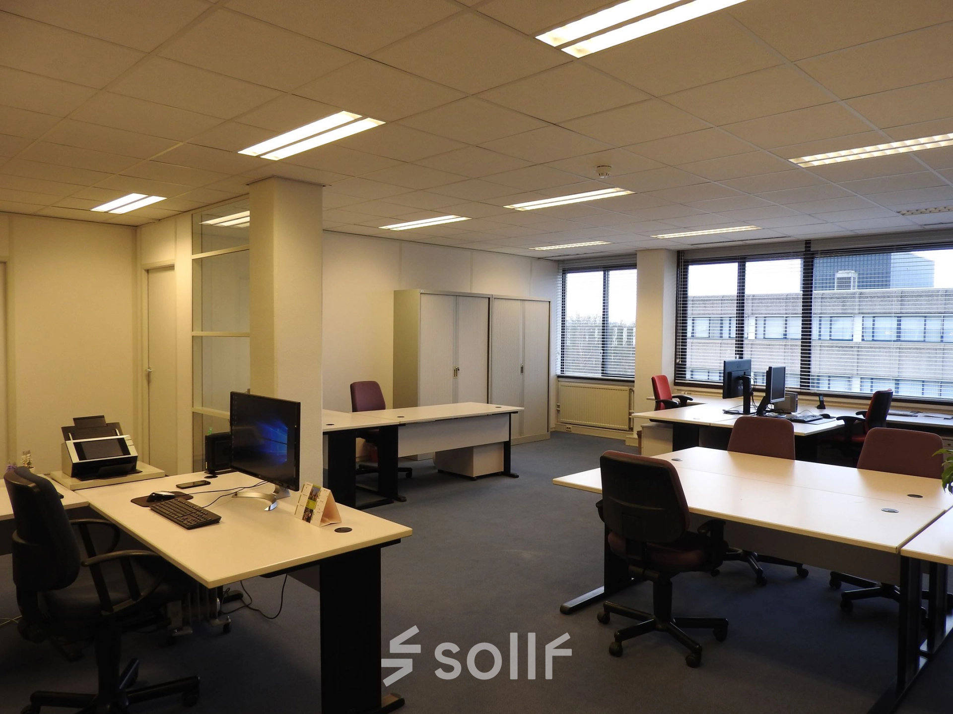 Spacious office space to rent at Zaagmolenlaan 4, Woerden, featuring multiple desks and chairs, ideal for professional workspaces.