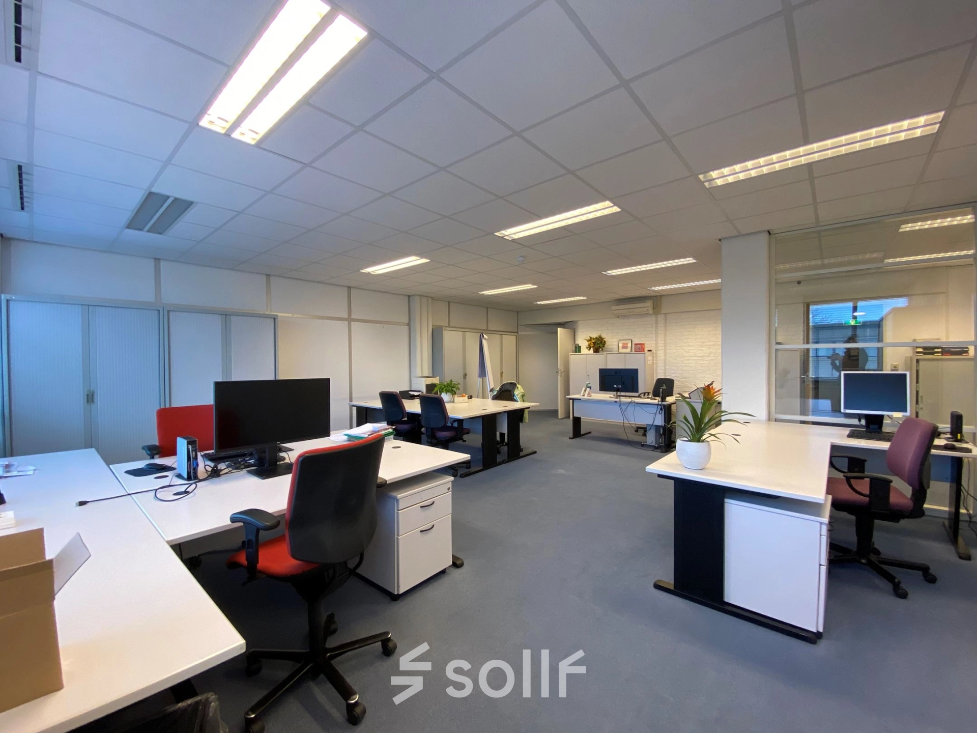 Interior view of a furnished office at Zaagmolenlaan 4, Woerden, showing multiple workstations available for office space rental. Bright and spacious with natural light.