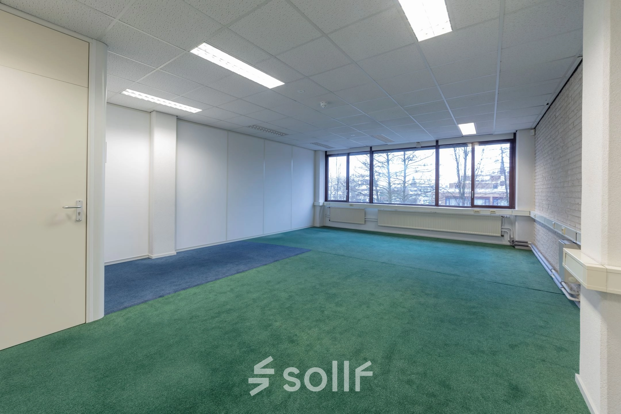 Spacious, unfurnished office space for rent at Zaagmolenlaan 4, Woerden, featuring large windows and carpeted flooring for office space rental.