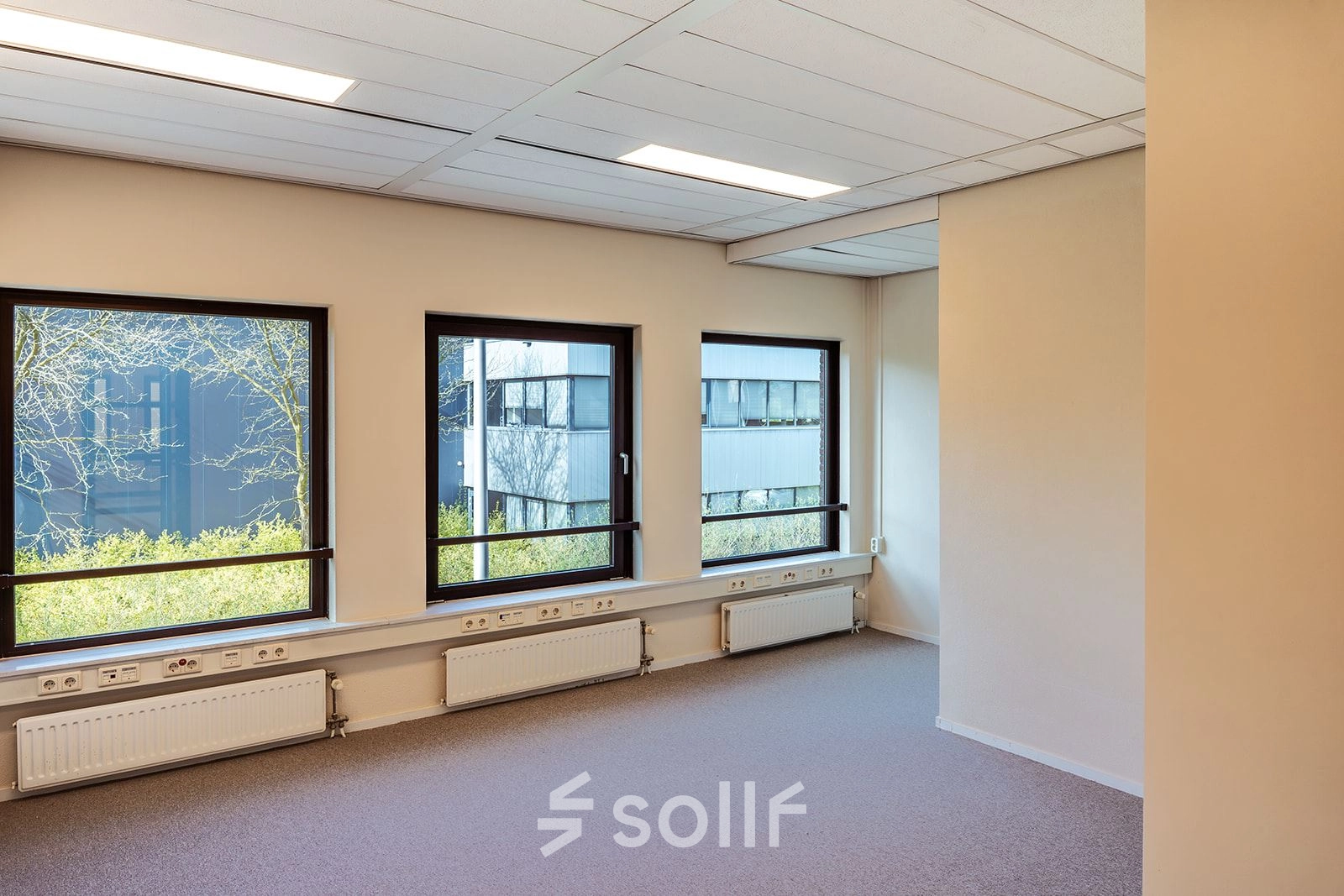 Bright office space at Mercurion 24, Zevenaar, featuring large windows and ample natural light, perfect for anyone looking to rent office space. This office to rent offers a serene working environment.