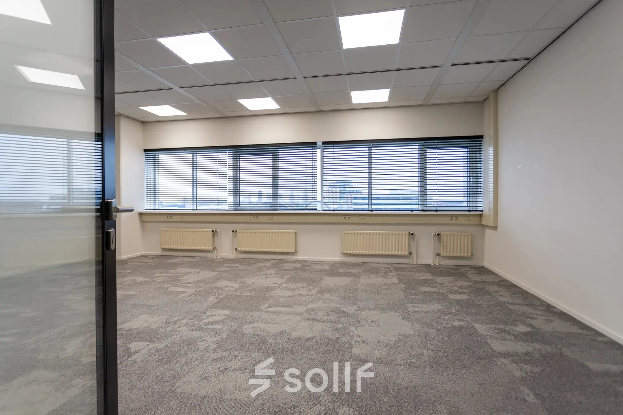 Spacious office space with large windows and ample natural light at Boerhaavelaan 40, Zoetermeer. Ideal for office space rental.
