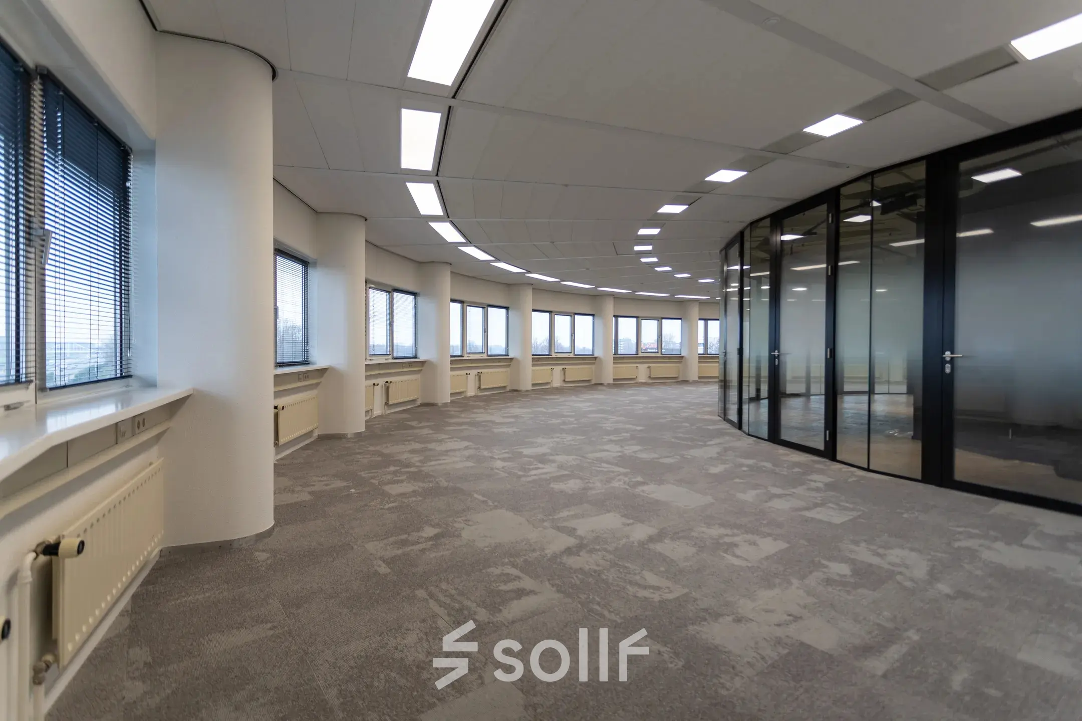 Spacious office space at Boerhaavelaan 40, Zoetermeer, featuring large windows and modern glass partitions. Ideal for office space rental with natural light.