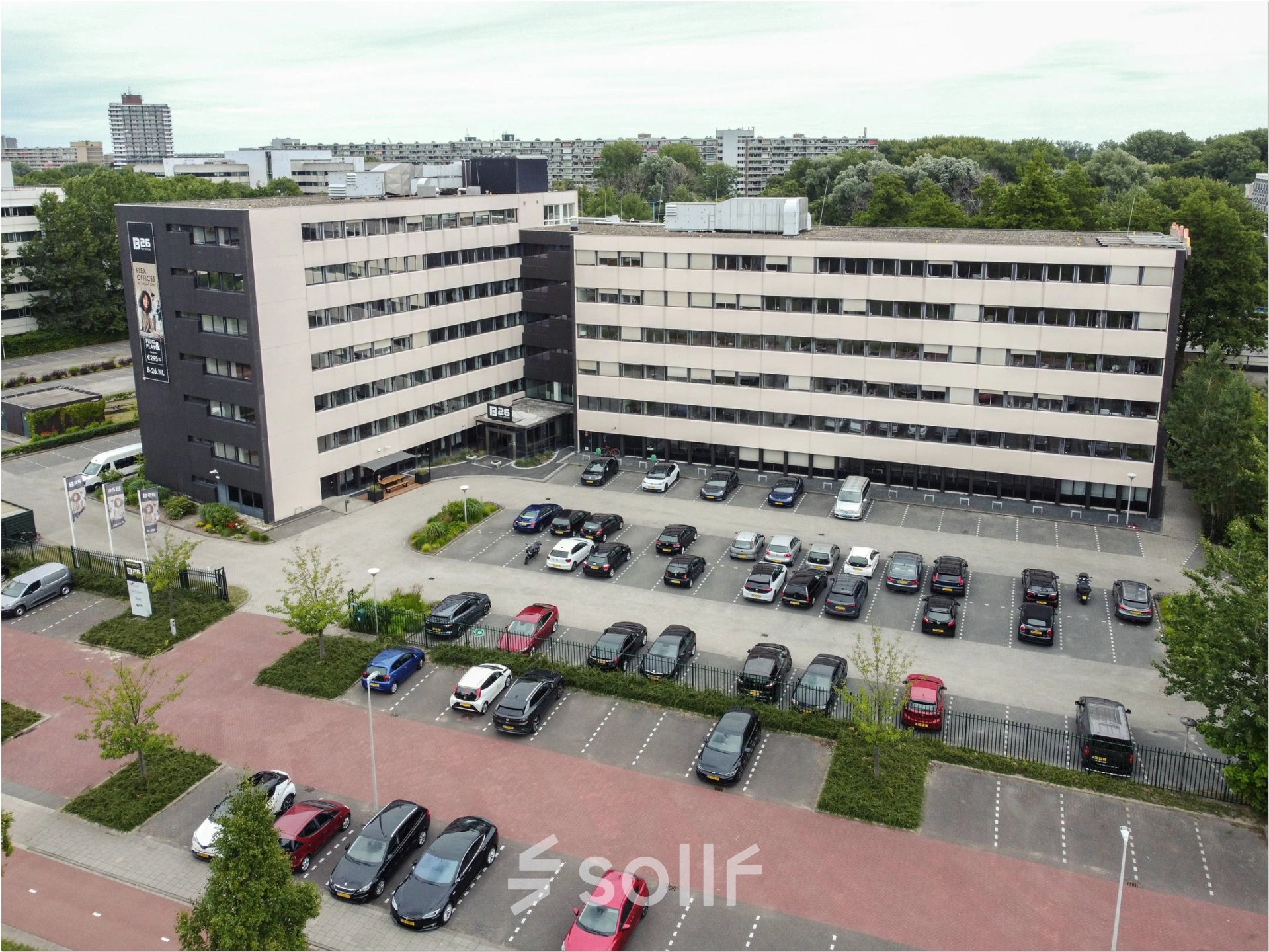Exterior view of a modern office building at Bredewater 26, Zoetermeer, featuring ample parking. Ideal for office space rental, the building offers a professional setting with multiple levels.