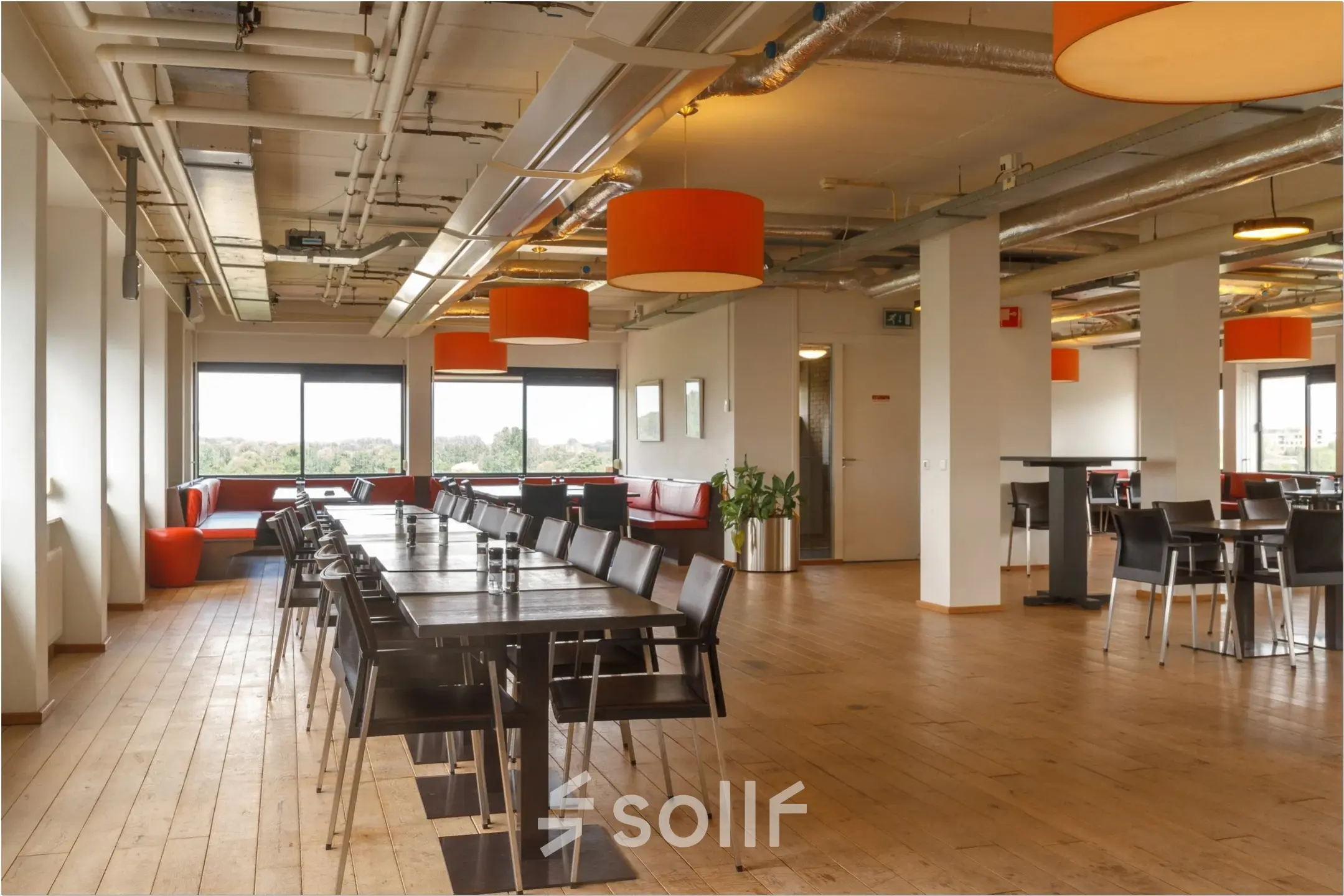 Bright office space with wooden flooring, modern furniture, and large windows at Bredewater 26, Zoetermeer, ideal for office space rental.