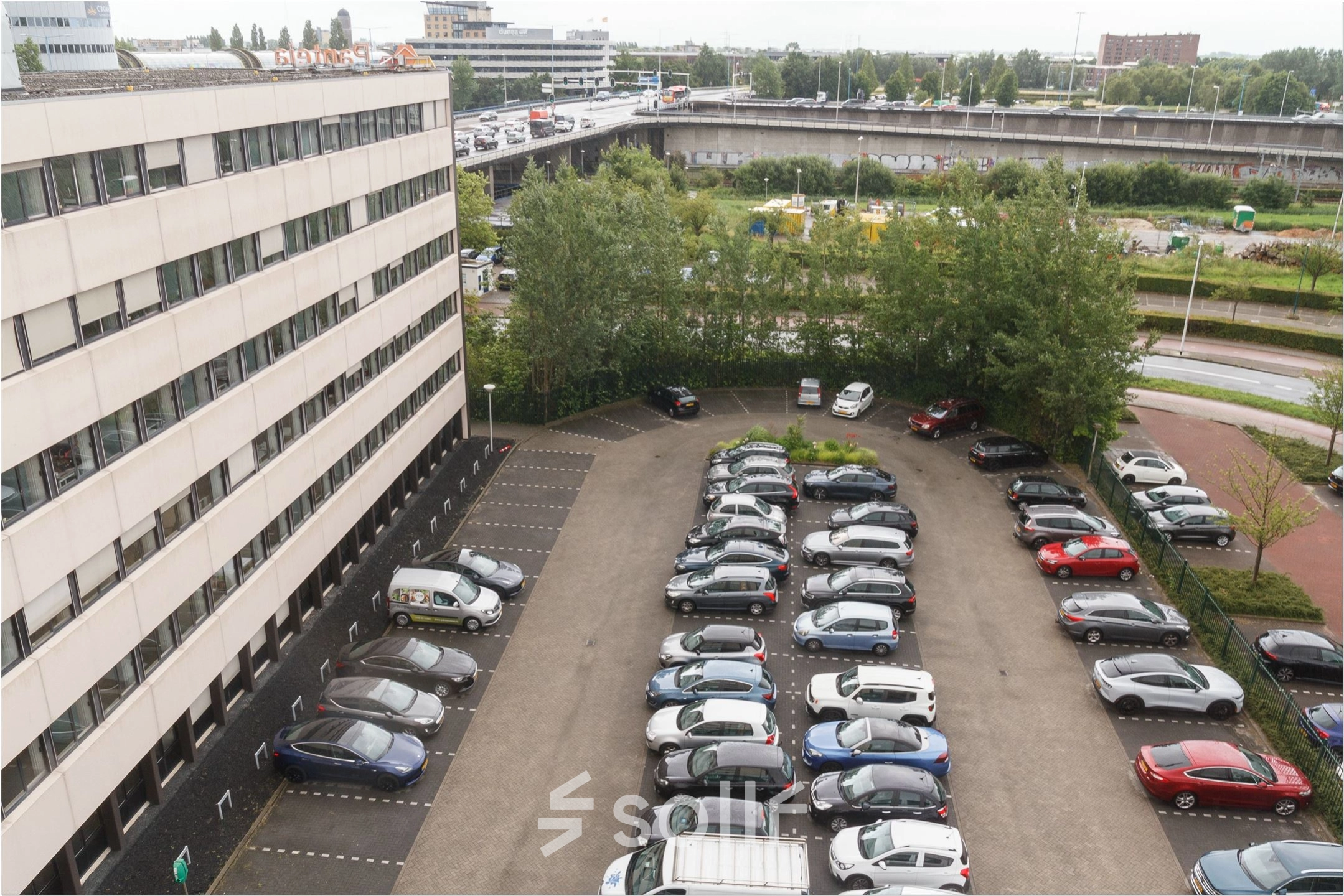 Exterior of the office building at Bredewater 26 in Zoetermeer, featuring a spacious parking area suitable for convenient office space rental access.
