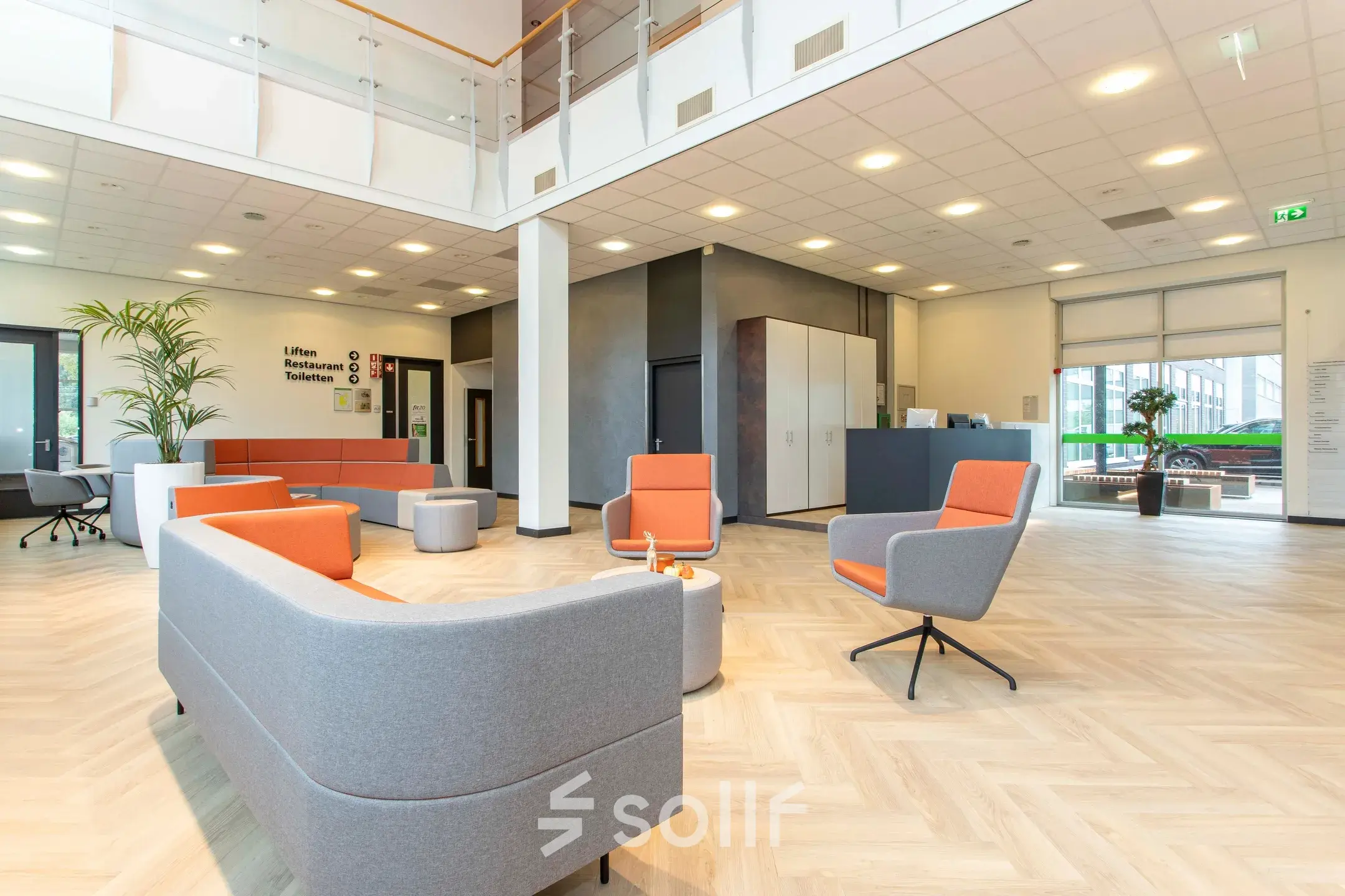 Spacious and modern lobby area at Louis Braillelaan 80, Zoetermeer, ideal for office space rental with stylish furniture and bright lighting.
