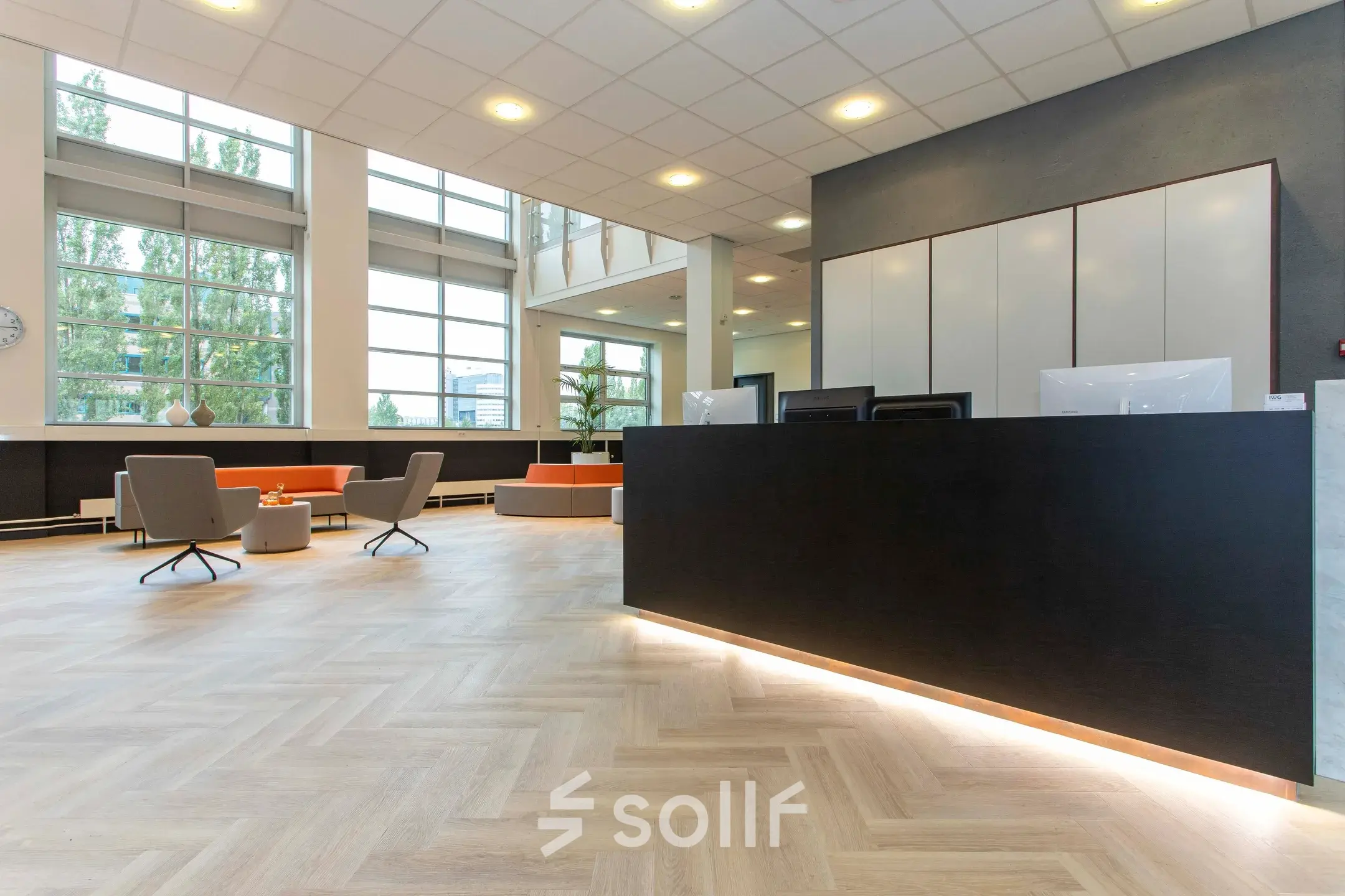 Spacious office reception area at Louis Braillelaan 80, Zoetermeer with modern decor, sleek seating, and large windows. Ideal spot for office space rental.