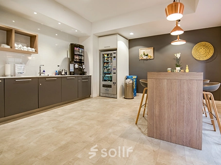 Modern office space at Badenerstrasse 47, Zürich Center featuring a furnished lounge area with a high table and chairs, ideal for office space rental.