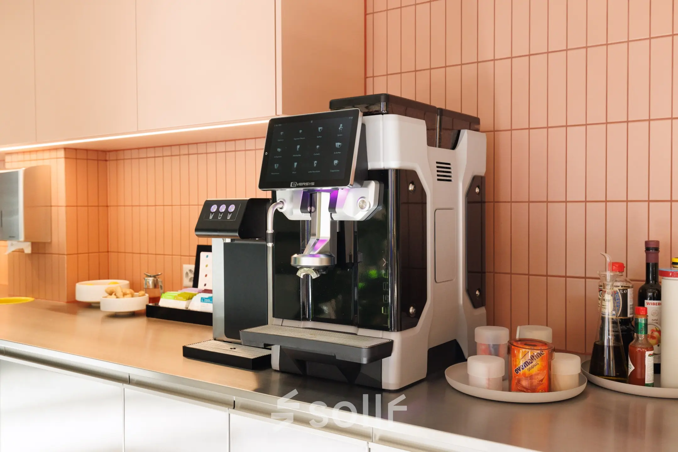 A modern pantry area featuring a sleek coffee machine and various condiments on a countertop, ideal for office space rental at Beethovenstrasse 48, Zürich Enge.