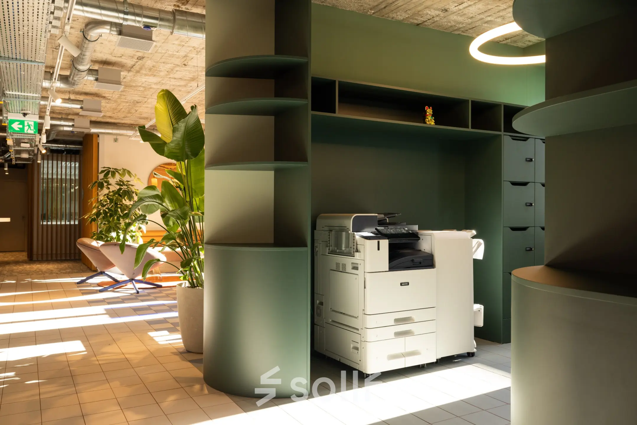 Modern workspace at Beethovenstrasse 48, Zürich Enge featuring stylish green cabinetry and a multifunction printer under natural lighting, ideal for office space rental.