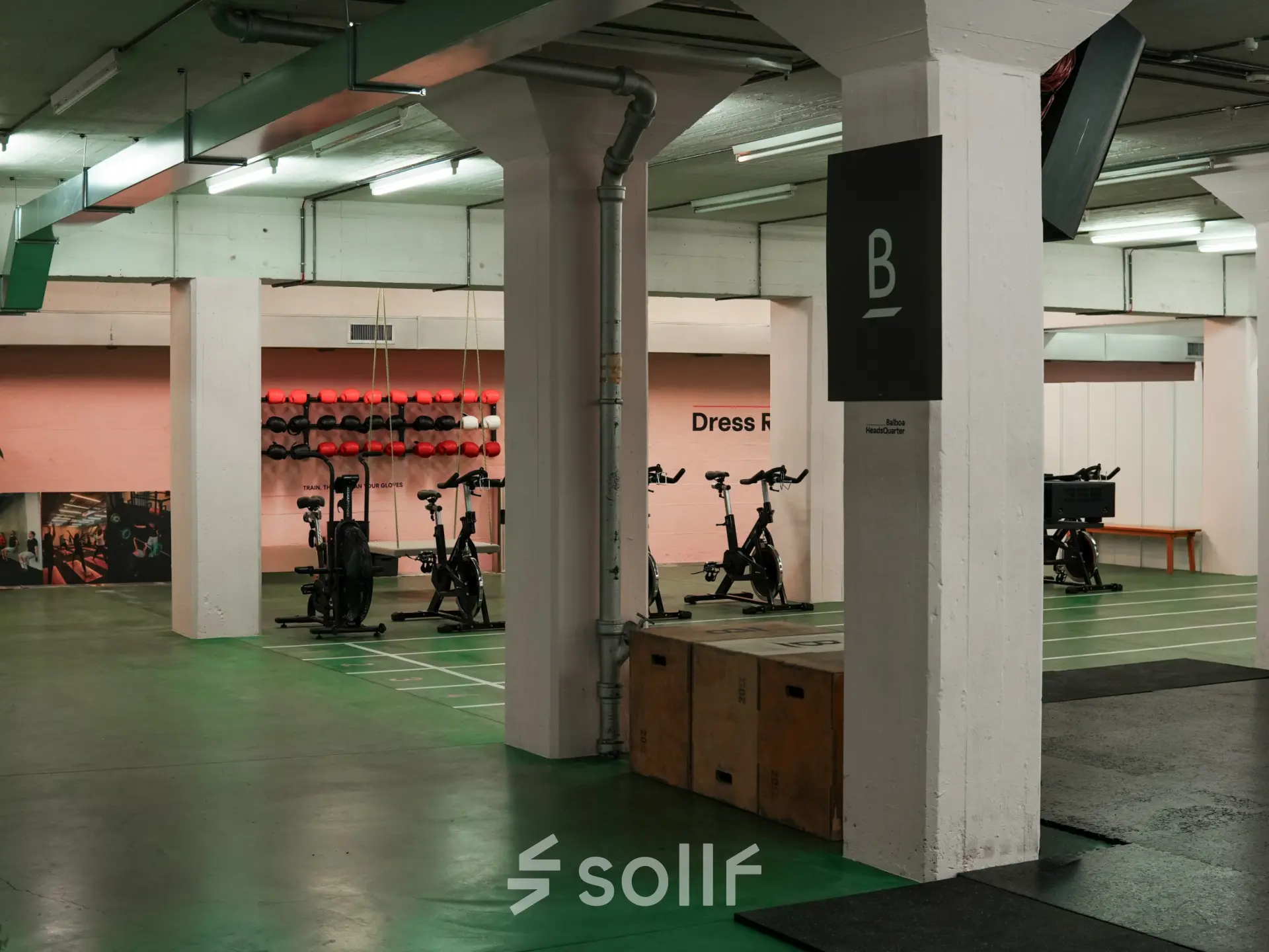 A well-lit interior at Beethovenstrasse 48, Zürich Enge, suitable for office space rental, featuring open areas and exercise equipment.