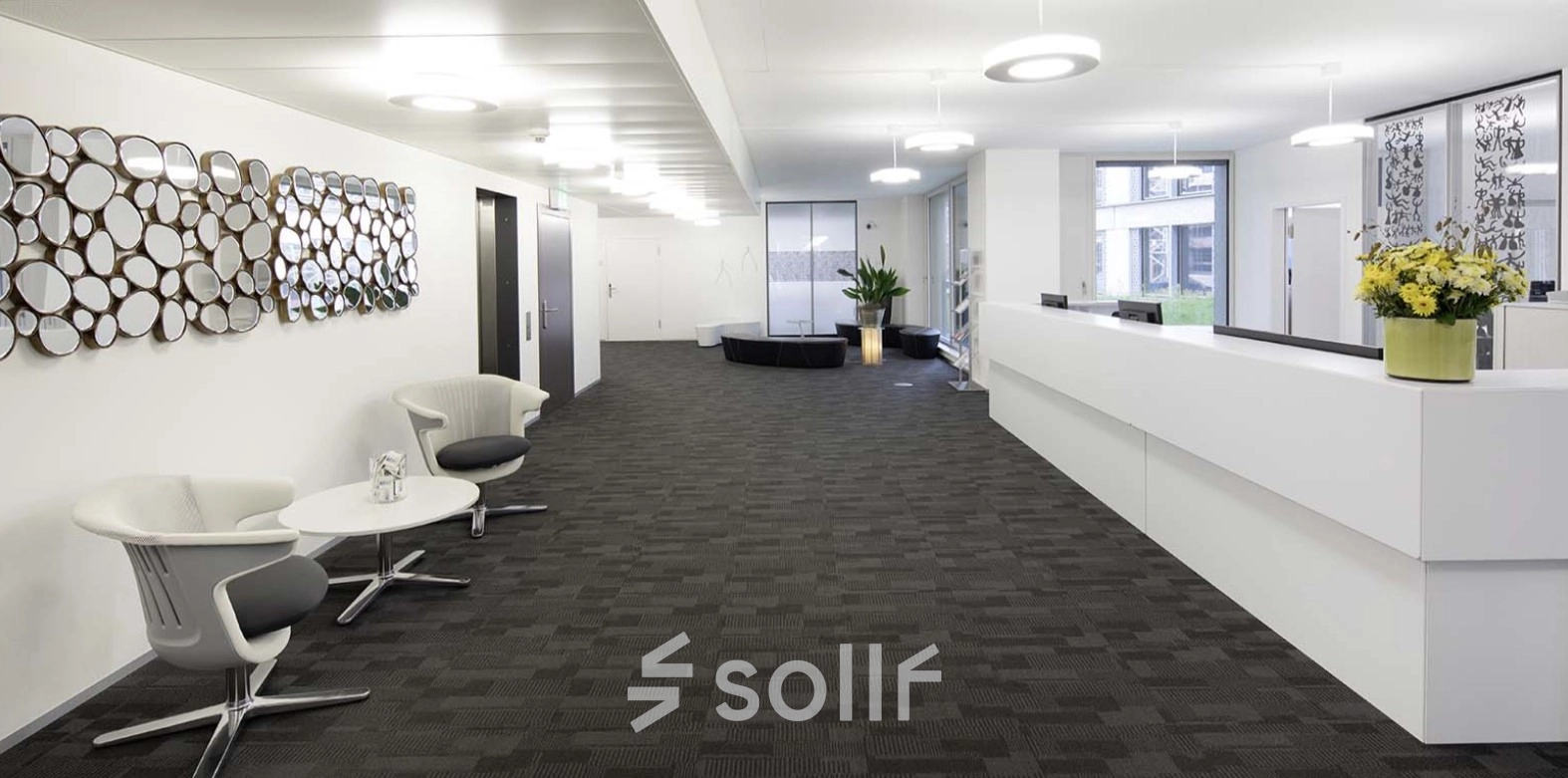 Spacious modern office at Europaallee 41, Zürich Mitte, featuring a sleek design with neutral tones and contemporary furniture. Ideal for office space rental.