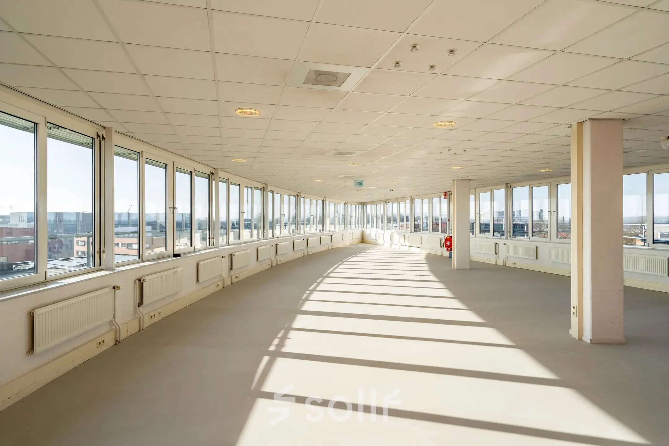 Spacious interior at Dokter van Deenweg 1, Zwolle, perfect for office space rental with large windows offering ample natural light.