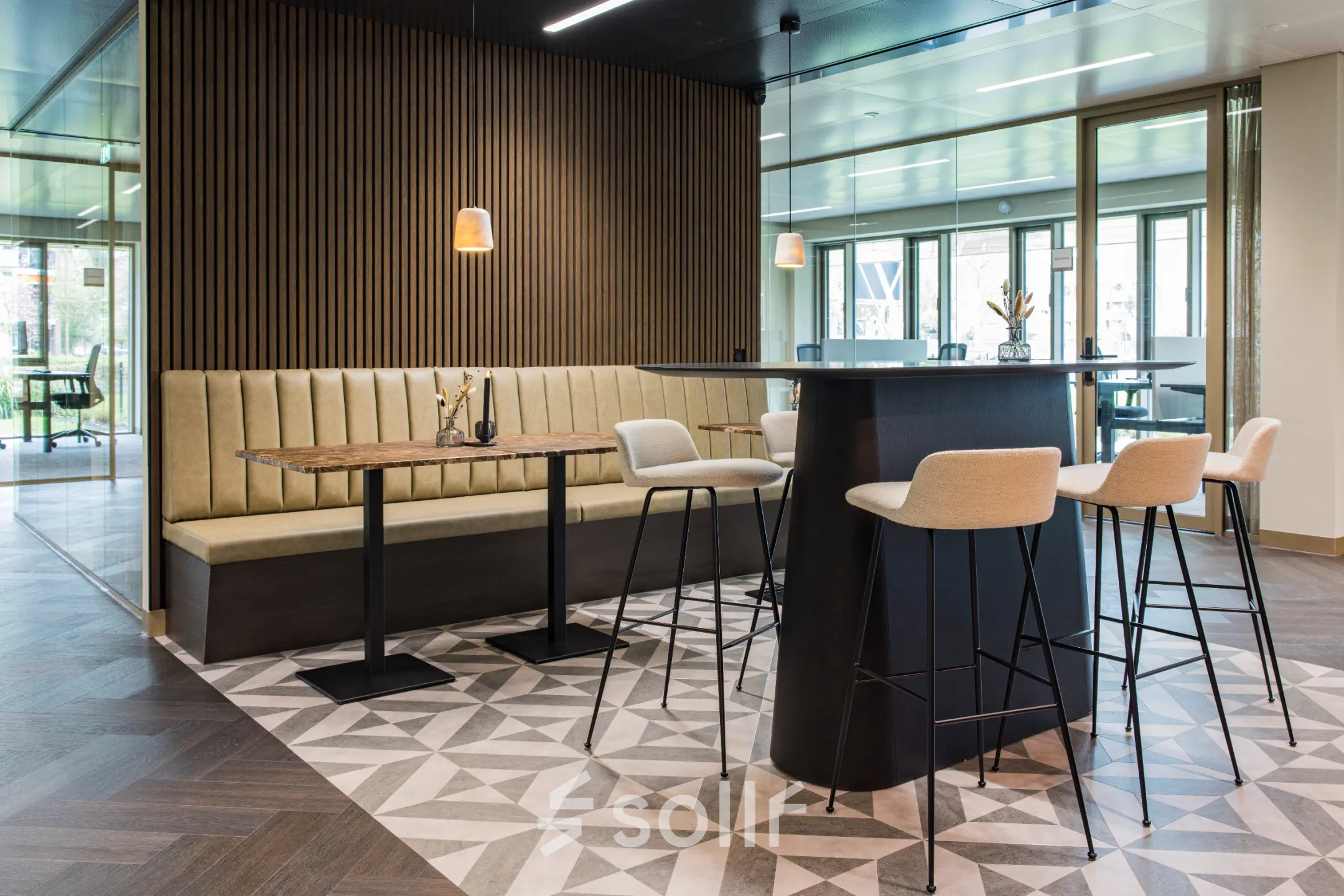 Moderne kantoorruimte huren in Amsterdam Buitenveldert op Walborg 2A met stijlvolle zithoek en hoge stoelen, ideaal voor informele vergaderingen.