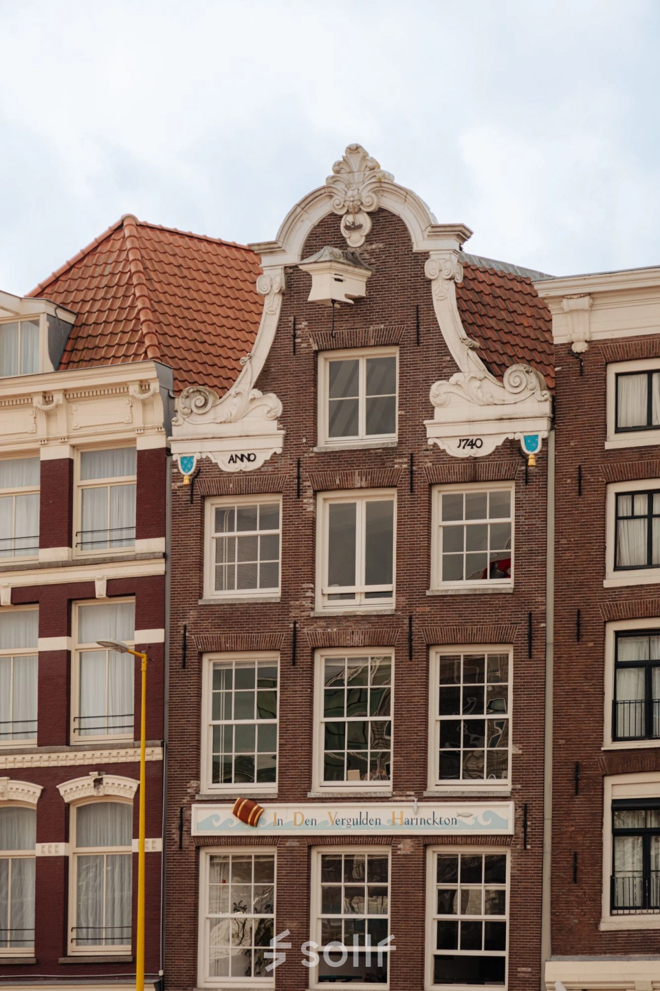 Gevel van een historisch kantoorpand op Prins Hendrikkade 14 in Amsterdam Centrum, karakteristieke architectuur, beschikbaar voor kantoorruimte huur.