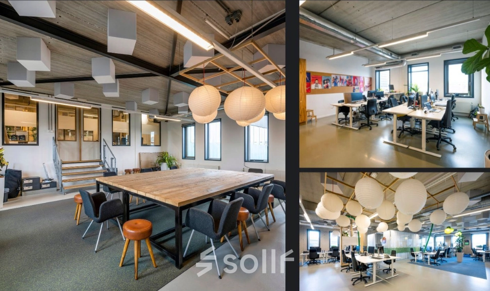 Moderne en lichte kantoorruimte huren in Amsterdam Noord, Meeuwenlaan 98-100. Ruime werkplekken met hangende lampen en voldoende daglichtinval. Comfortabele zithoek met stoelen rondom een tafel.