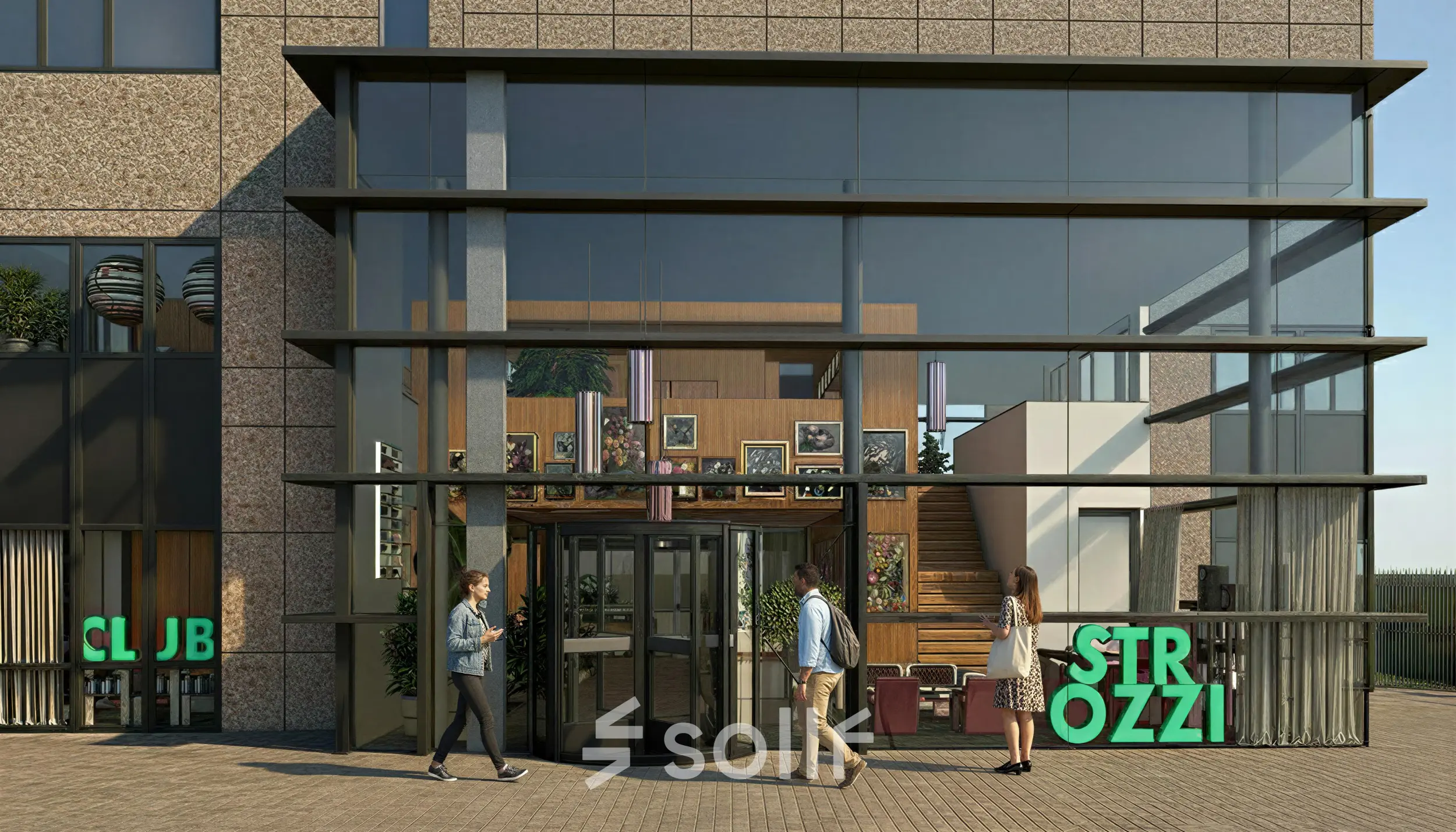 Buitenzijde van een kantoorpand op Barbara Strozzilaan 101 101 in Amsterdam Zuidas met een glazen entree waar mensen binnenkomen en bladeren. Ideale locatie om kantoorruimte te huren.