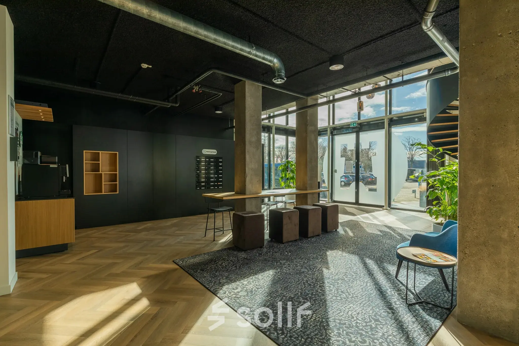 Moderne kantoorlobby op Prins Willem Alexanderlaan 701, Apeldoorn, geschikt om te huren, met een minimalistisch ingericht interieur en natuurlijk licht van grote ramen.