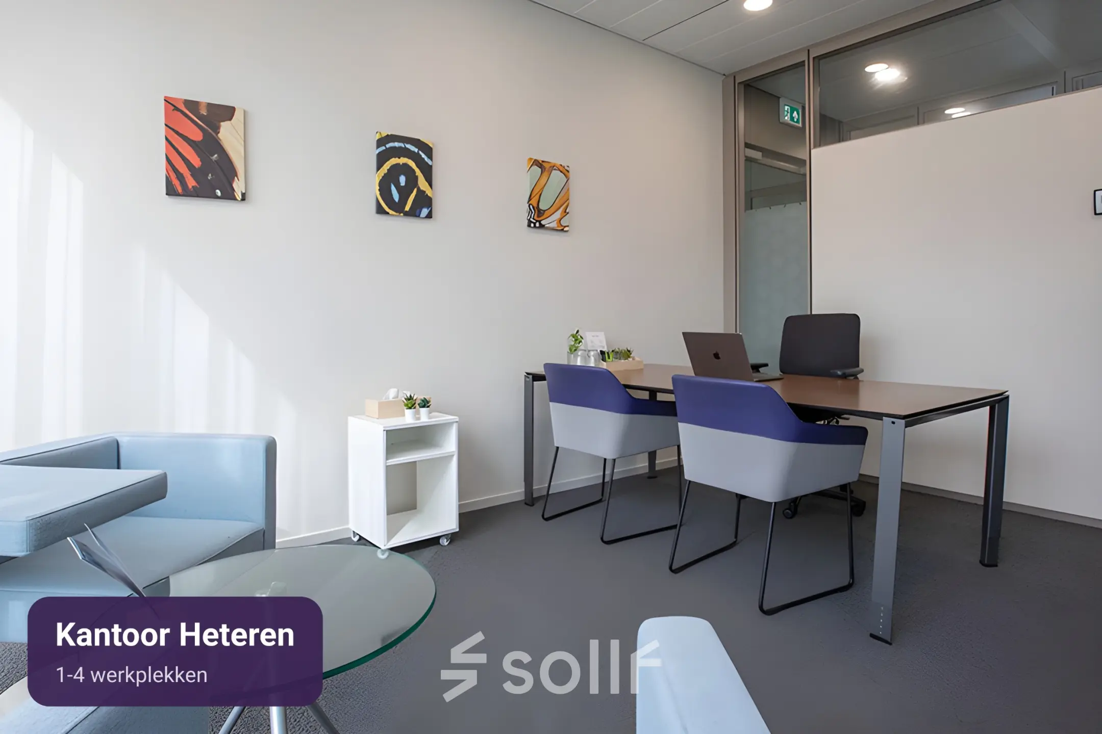 Moderne kantoorruimte te huur in Arnhem Zuid met strakke inrichting, inclusief vier werkplekken en kunstwerken aan de muur.