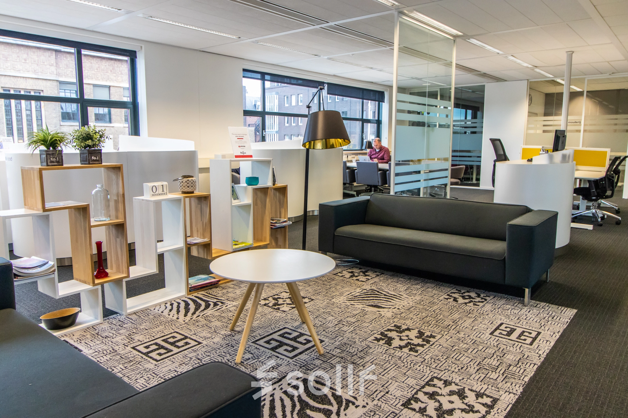 Moderne kantoorruimte huren aan Ceresstraat 1, Breda Centrum-Station, met comfortabele banken, decoratieve elementen en werkplekken met apparatuur.