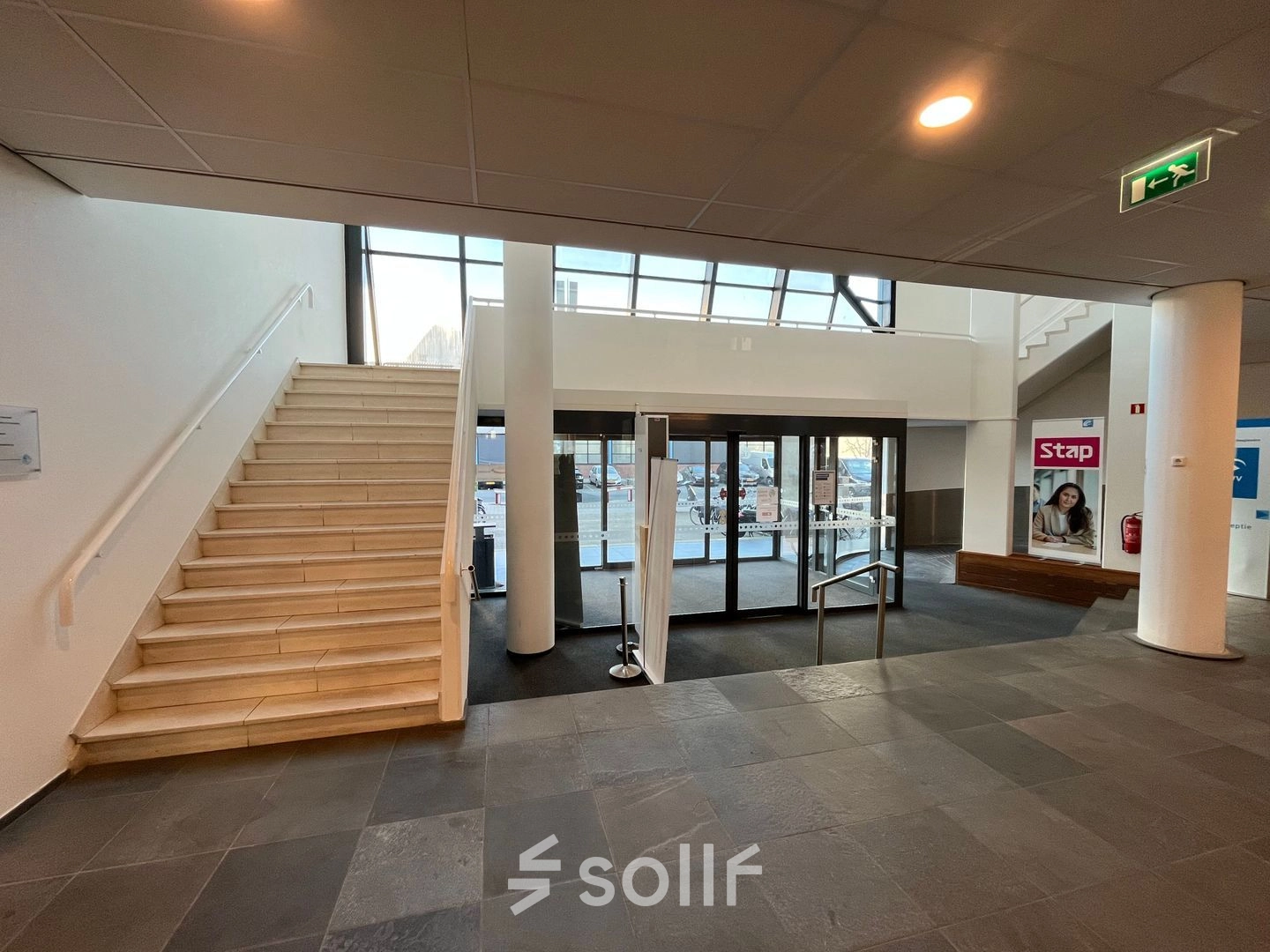 Entree van het kantoorpand aan de Platinaweg 10 in Den Haag Escamp, met een trap en glazen entree. Kantoorruimte huren in een moderne omgeving.