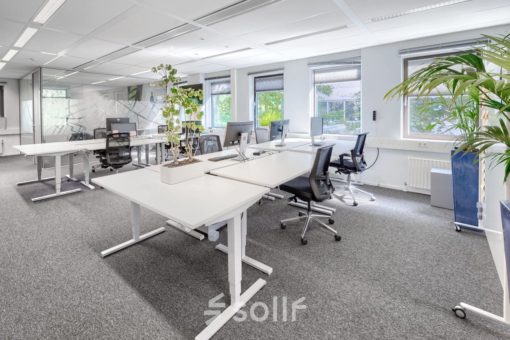 Lichte kantoorruimte met moderne bureaus en ergonomische stoelen, geschikt voor dynamisch werken. Grote ramen zorgen voor natuurlijke lichtinval. Optimaal voor wie een kantoorpand in Diemen wil huren.