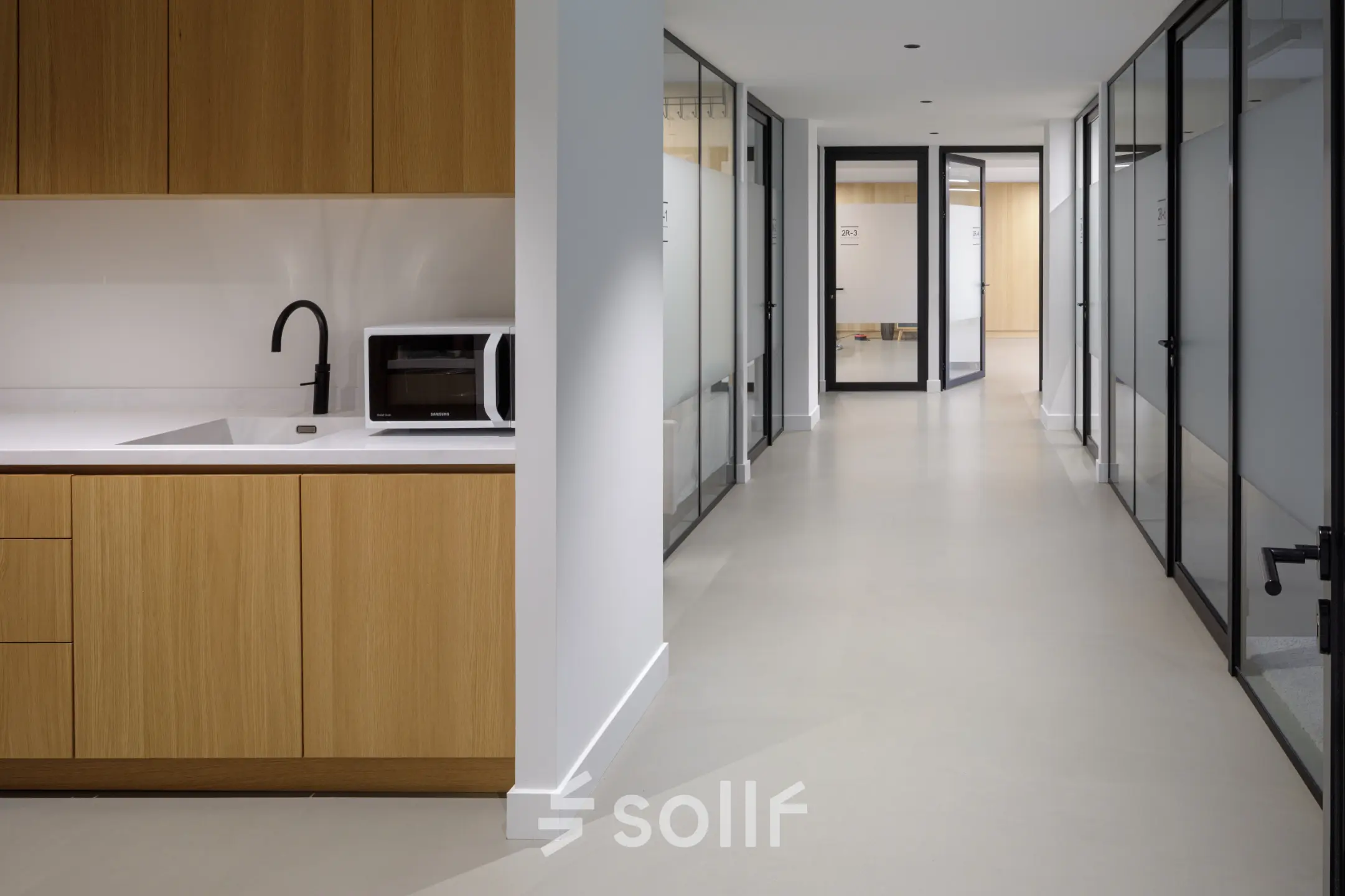 Kantoorruimte huren aan Paradijslaan 30-38 in Eindhoven Centrum met moderne glazen kantoorwanden, lichte vloer en een pantry met houten kasten. Geschikt voor diverse zakelijke activiteiten.