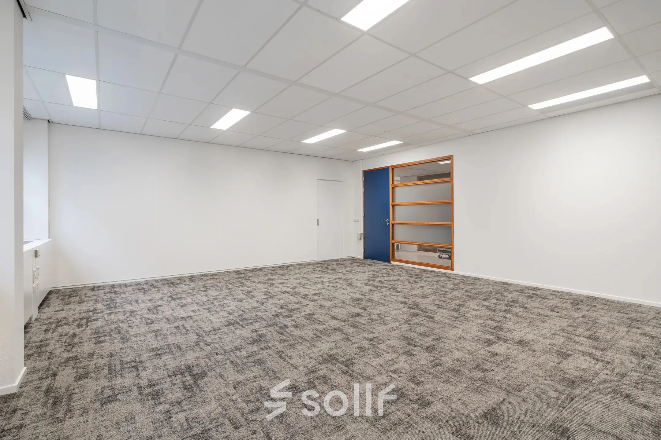 Lege kantoorruimte met tapijtvloer en witte muren op A. Hofmanweg 5A, Haarlem Waarderpolder. Ideaal voor kantoren die flexibiliteit in inrichting zoeken bij het huren van kantoorpanden.