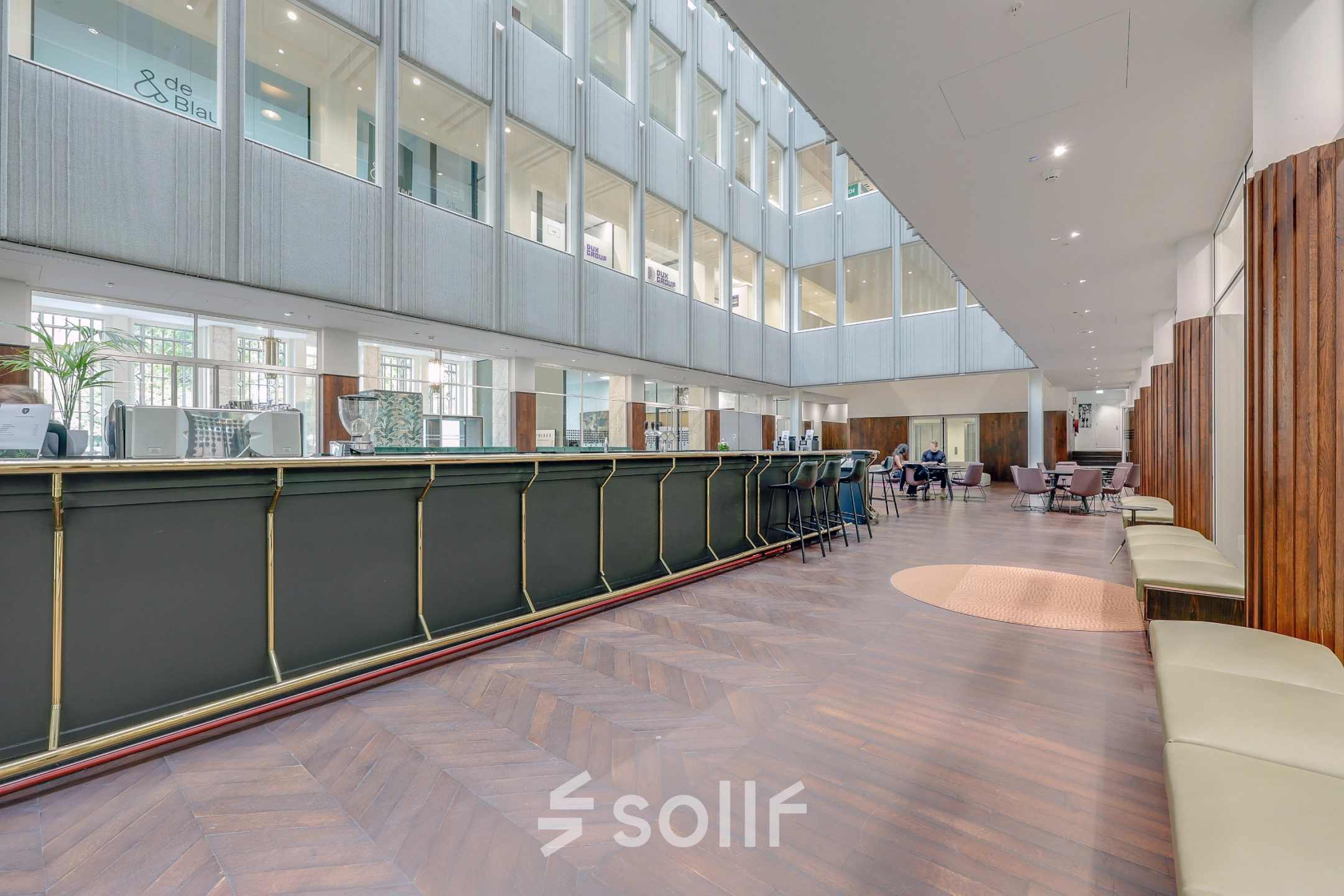 Moderne kantoorruimte te huur op Blaak 34, Rotterdam Centrum, met een ruime, open indeling en comfortabele zitplekken. Zakelijke activiteiten zijn zichtbaar in deze lichte en uitnodigende omgeving.