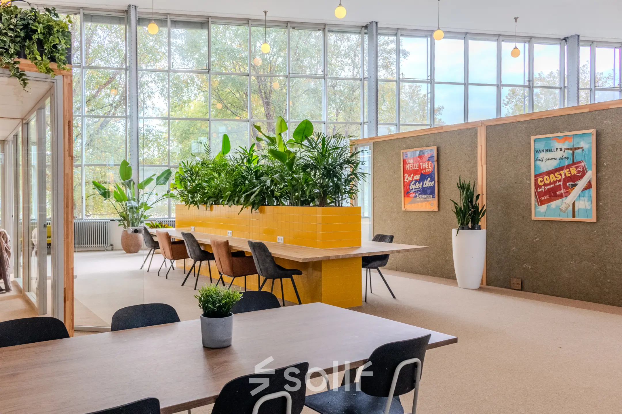 Kantoorruimte op Van Nelleweg 1, Rotterdam Delfshaven, met moderne inrichting, grote ramen, planten en een lange vergadertafel. Geschikt voor wie een kantoorpand wil huren in een dynamische omgeving.