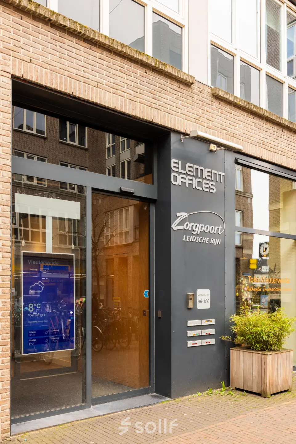 Exterieur van een kantoorpand aan Middenburcht 136 in Utrecht Leidsche Rijn. Het pand heeft een moderne glazen ingang en een bord met bedrijfsnamen naast de deur.