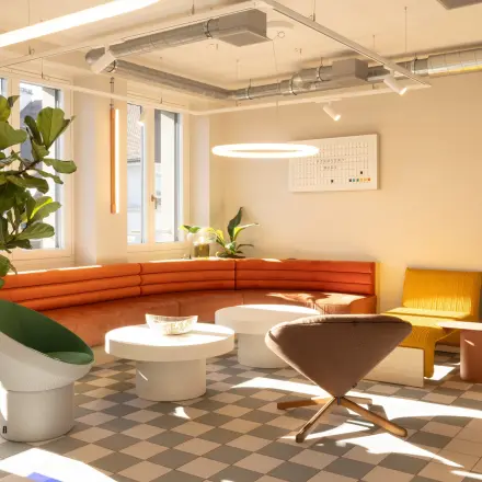 Modernes, möbliertes Büro zur Miete an der Beethovenstrasse 48 in Zürich Enge mit stilvollen Sesseln und einer Ecke mit roter Couch.