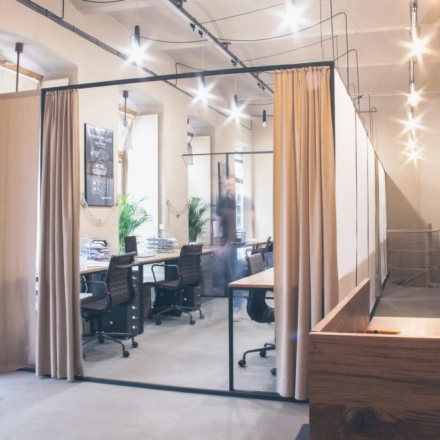 Furnished office space at Zimmermanngasse 8, 1090 Vienna, featuring an open workspace with several desks and chairs, ideal for office space rental in a professional setting.