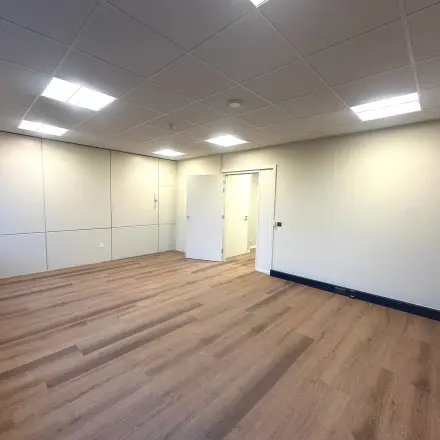 Unfurnished office space at Hollandse Kade 38, Abcoude, showcasing bright lighting and wooden flooring, available for rent.