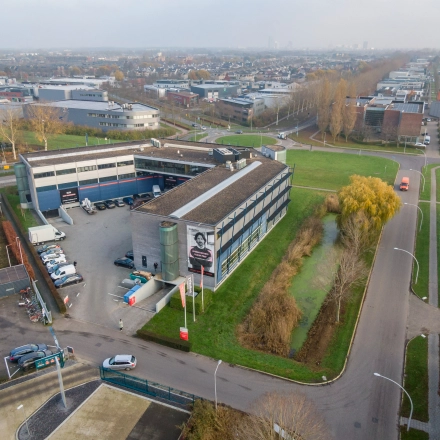 Aerial view of the office building located at Transistorstraat 151 in Almere Poort, Almere, showing the exterior surroundings and parking area. Ideal for office space rental in a convenient business location.