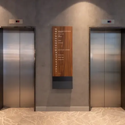 Elevator area with two lifts and a floor directory at Landdrostdreef 124, a potential location for office space rental in Almere Stad.