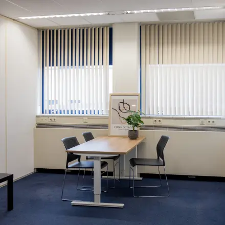 Bright office space rental available with a table and chairs at Markerkant 1310, Almere Stad. Ideal office to rent for meetings or collaborative work.