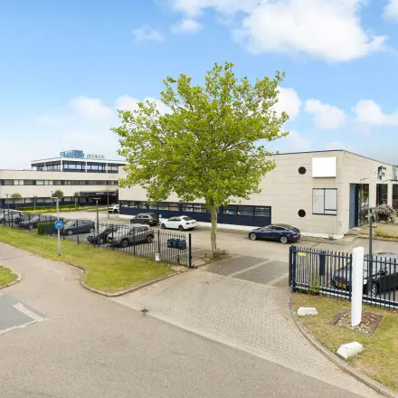 Exterior view of office buildings at Markerkant 1310, Almere Stad, showcasing ample parking and greenery, ideal for office space rental opportunities.