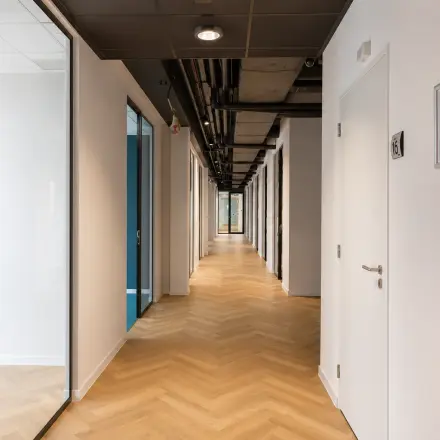 Bright corridor at Veluwezoom 15 in Almere Stad offering access to various office spaces available for rent.
