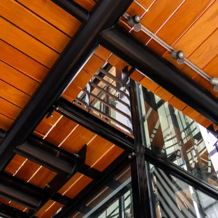 Architectural detail of office space at Maanlander 43, featuring wooden panels and glass elements.