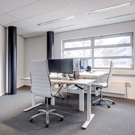 Modern office space rental at Maanlander 47, Amersfoort Calveen, featuring two desks with monitors and chairs, ideal for rent office space.