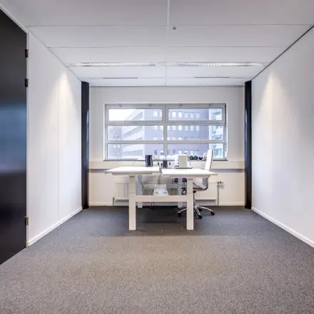 Bright office space at Maanlander 47 in Amersfoort Calveen, featuring a clean, modern design with a window offering natural light. A perfect office space rental option for your business needs.
